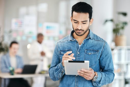 Tablet, web design and man developer typing and working startup website development for the web or